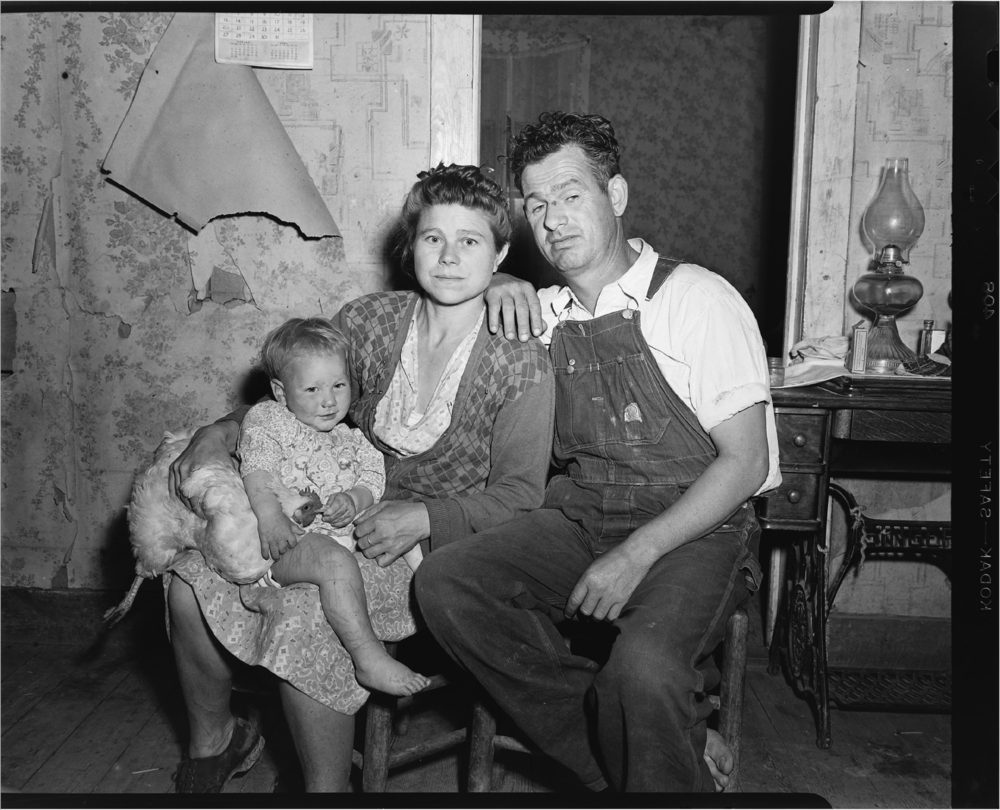 In a photo from the Shipp Studio Archive, chicken (left), daughter, mother and father sit for their portrait in rural Tennessee.