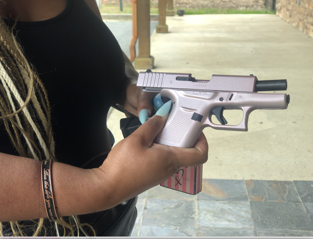 Jessica Schefield shows off her pink pistol that she just got cleaned.