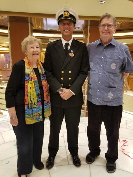 Renee (left) and Clyde Smith with the cruise ship captain as they renewed their wedding vows aboard the Diamond Princess.