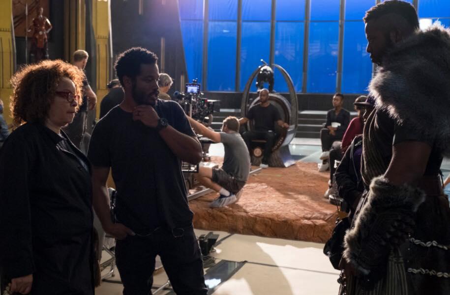 Qualen Bradley sitting in for Chadwick Boseman on set of Black Panther with director Ryan Coogler in the foreground.