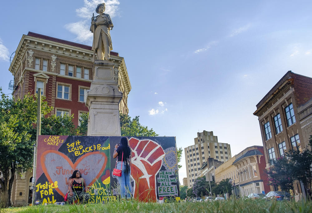 Artists boxed in the base of the Confederate statue in Macon, Ga. to create a canvass for expressions of Black pride on #Juneteenth