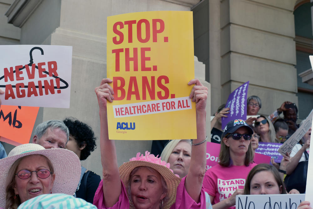 Abortion rights supporters hold signs at a rally at the Georgia State Capitol Tuesday, May 21, 2019.