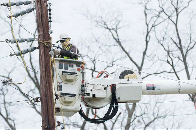 A lineman works to restore power in Talbotton Monday after a tornado came through west Georgia.