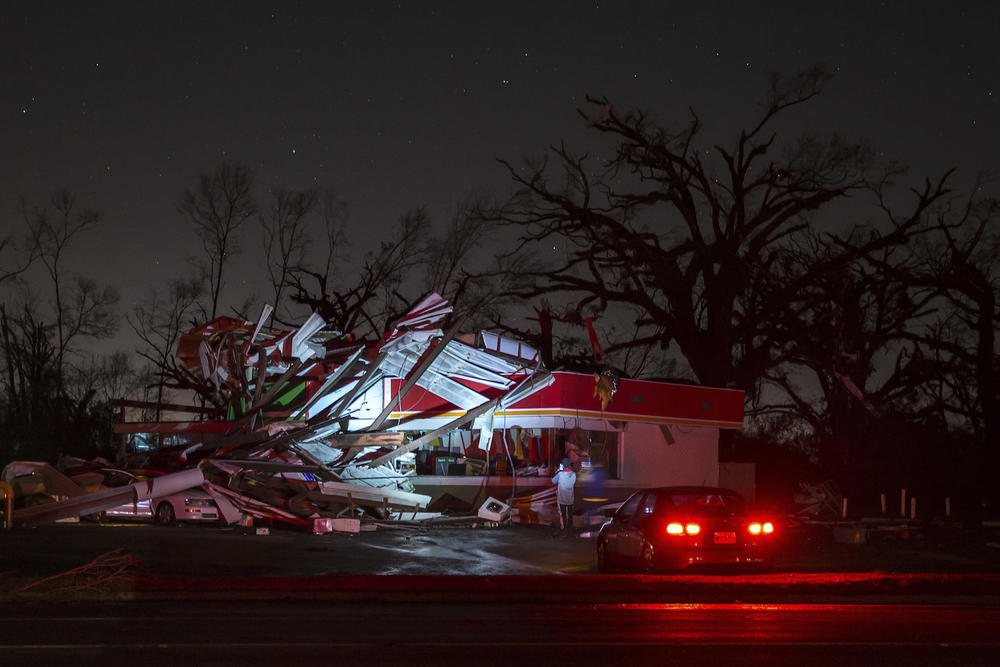 People stop to take a photo of a gas station damaged by an apparent tornado, Sunday, Jan. 22, 2017, in Albany, Ga.