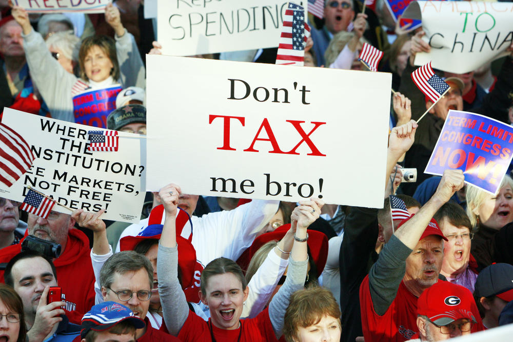 A woman holds a sign that reads "Don't tax me bro! " during the Atlanta Tea Party tax protest Wednesday, April 15, 2009 in Atlanta.