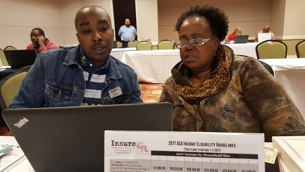ACA navigator Ted Hall guides Lizella's Donna Hughes as she renews her insurance under the Affordable Care Act. This happened during a one-day event at the Macon Centerplex.