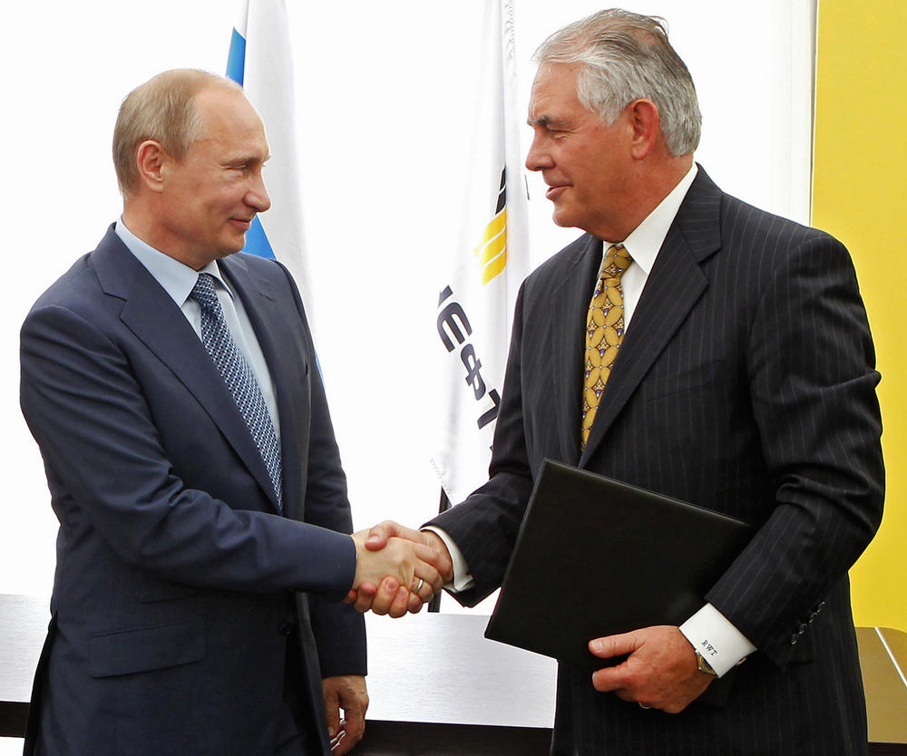 Russian President Vladimir Putin, left, and ExxonMobil CEO Rex Tillerson shake hands at a signing ceremony of an agreement between state-controlled Russian oil company Rosneft and ExxonMobil at the Black Sea port of Tuapse on June 15, 2012,.