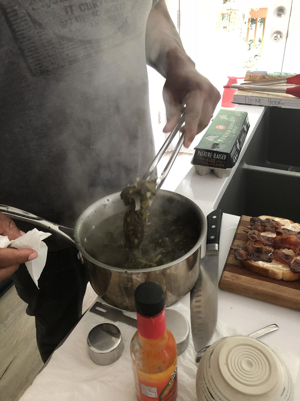 Todd Richards cooks collard greens in his home kitchen in Atlanta.