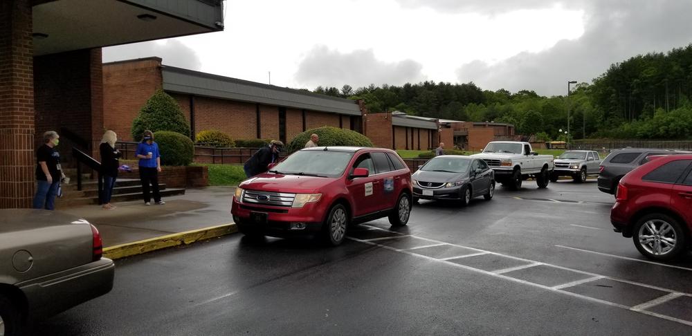 Students from Towns County High School pick up their caps and gowns Friday prior to a senior parade.