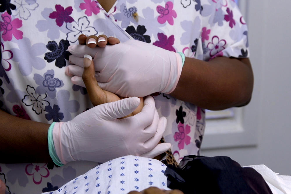 A nurse at Reproductive Health Services clinic in Montgomery, Ala. comforts a patient. 