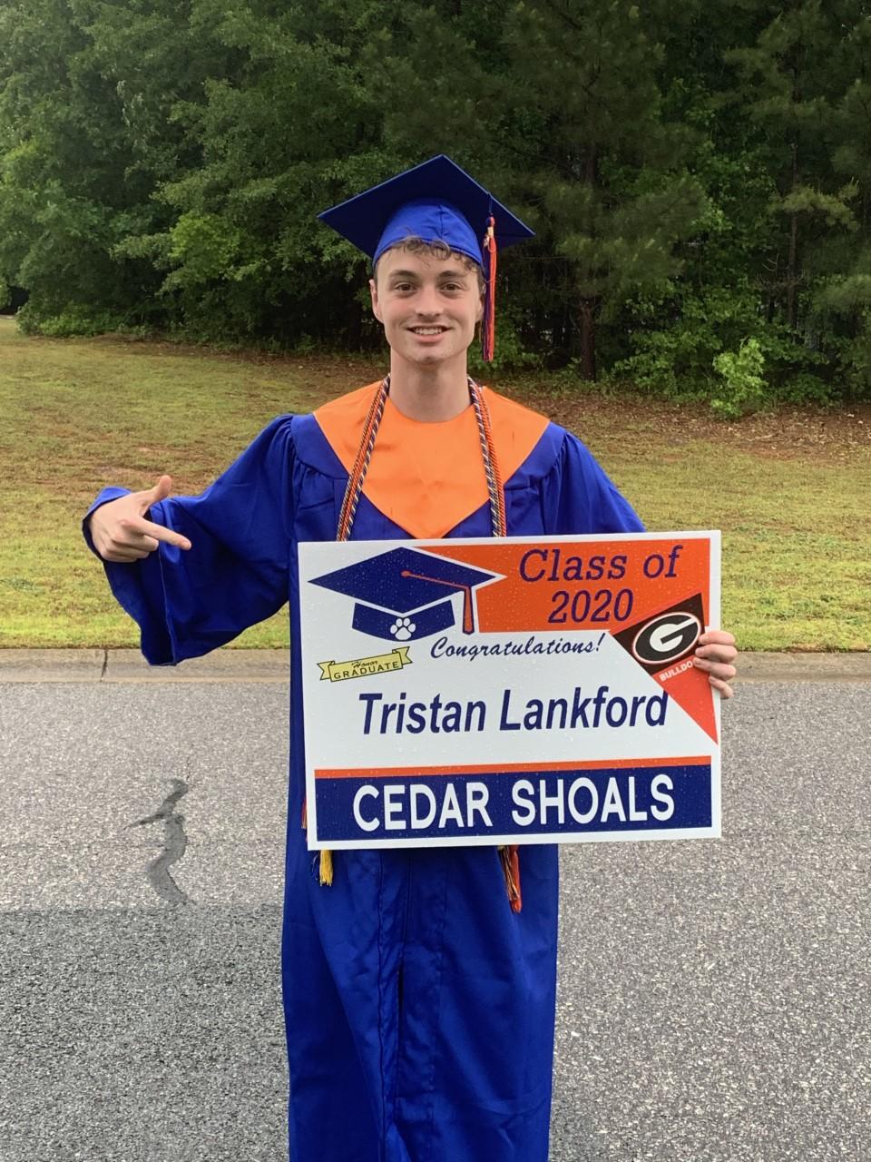 Tristan Lankford poses in his high school graduation robes at his home in Athens, Georgia.