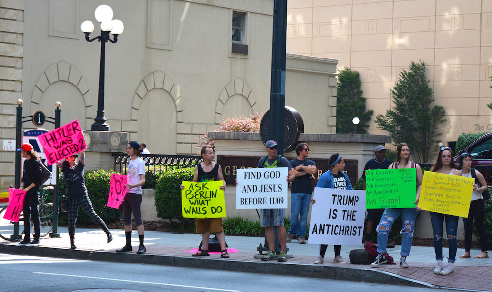 Protesters gathered across the street from the Fox Theatre in Atlanta where Donld Trump was speaking on Wednesday, June 15, 2016. 