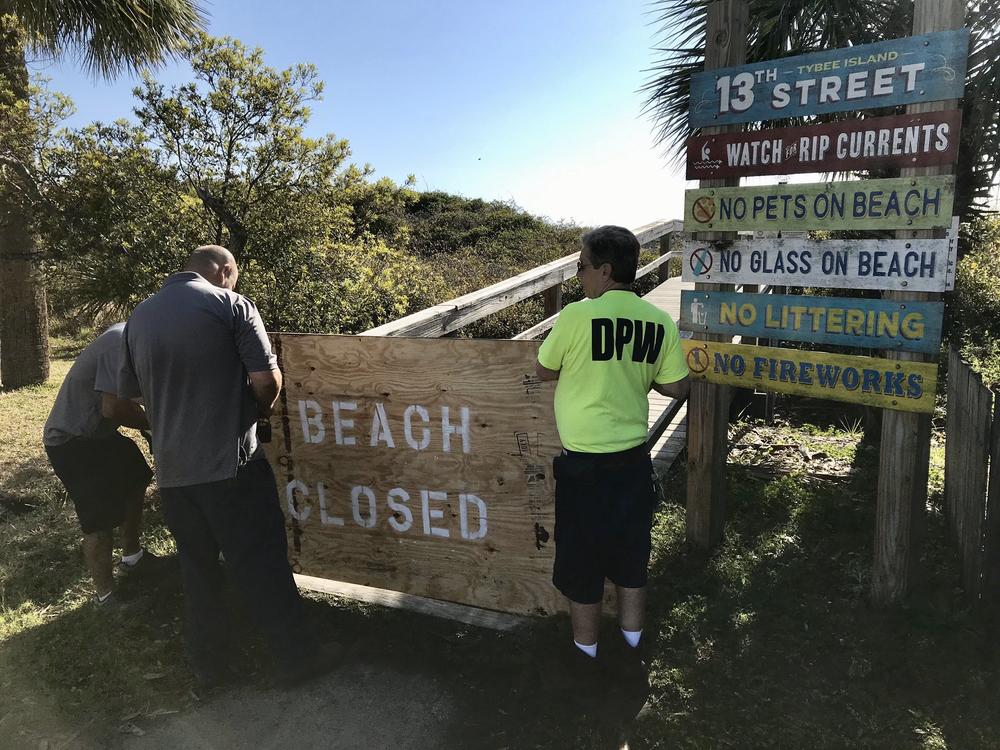 Tybee Island workers close access to the beach after Mayor Session's order.