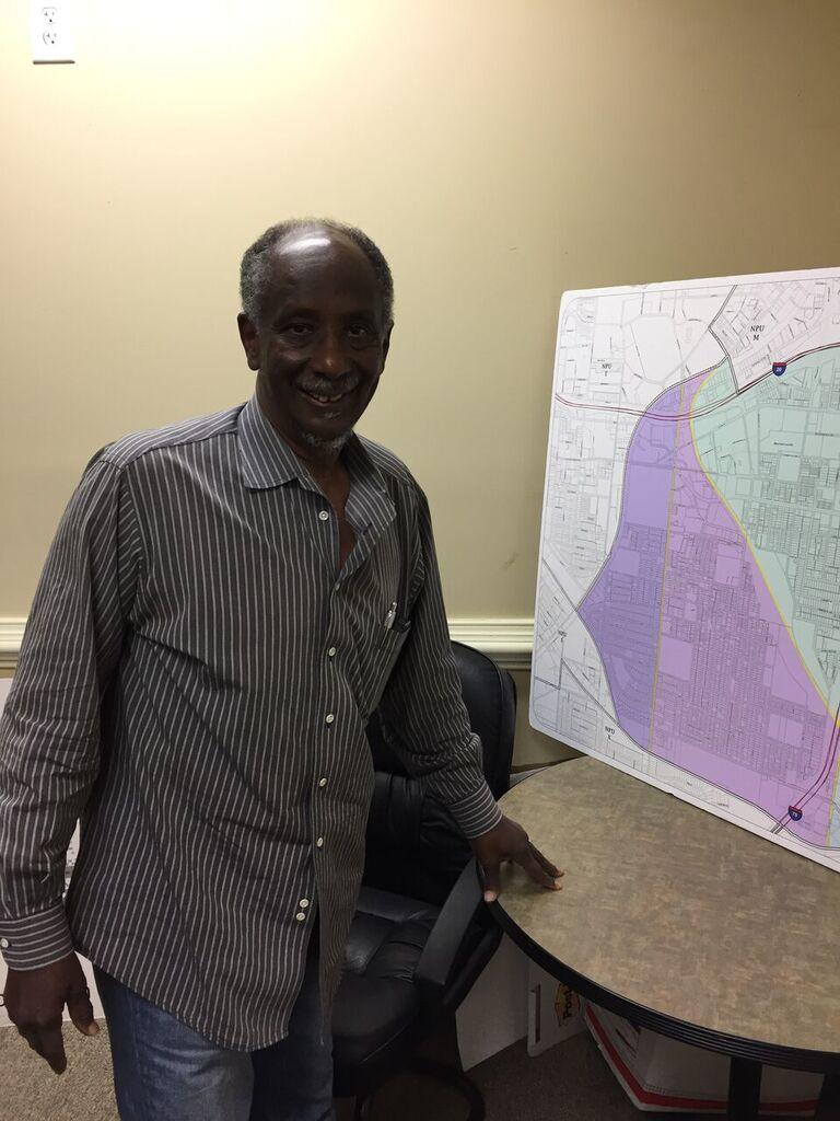 Douglas Dean stands before a map of downtown Atlanta's NPU-V where Turner Field will be redeveloped. 