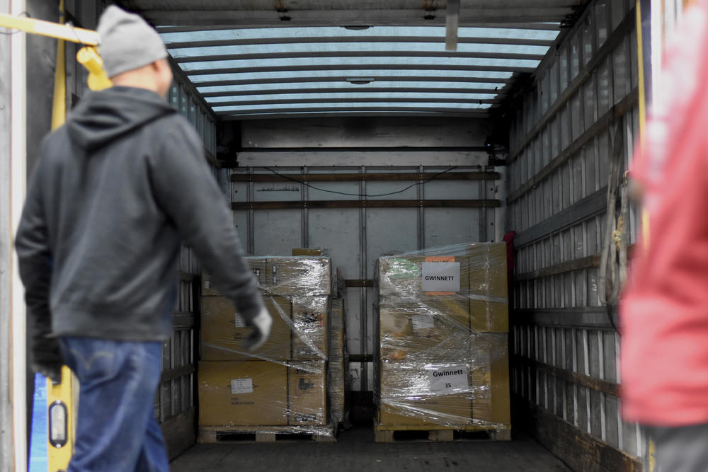 Workers load voting equipment into a truck at the state's election warehouse in Cobb County.