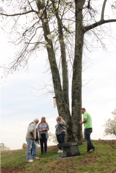 Friends and family gather at the grave of Dustin Hart and Austin Hart. Both sons of Heather Wysocki died in their mid-20s. 