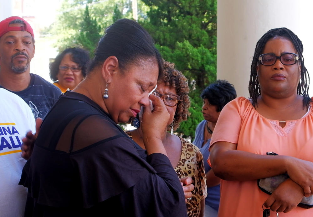 Macon NAACP chapter president Gwen Westbrook wipes away tears before a press conference where she asked for a curfew for teens to stem homicides. 