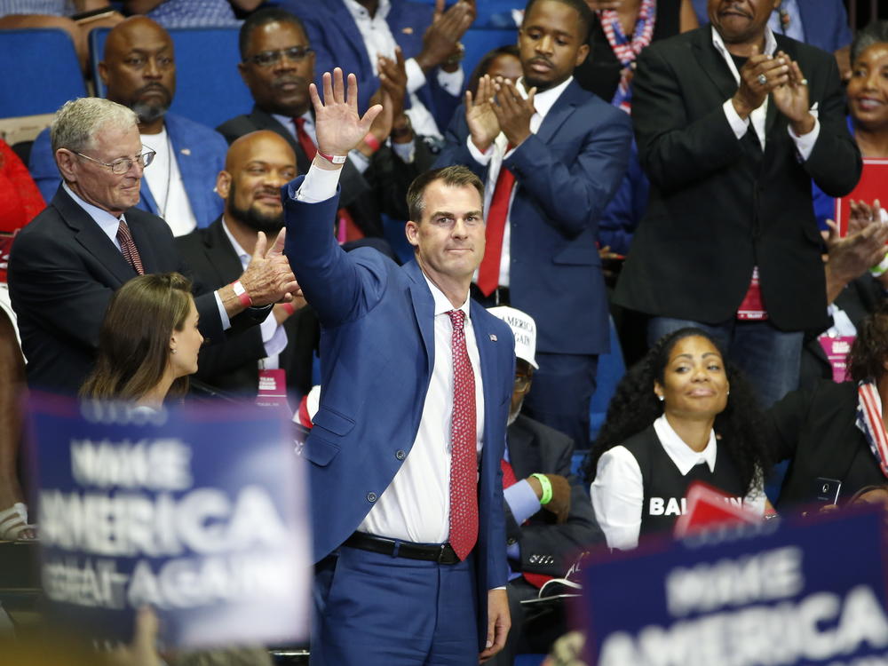 Oklahoma Gov. Kevin Stitt attends President Trump's campaign rally last month in Tulsa. Stitt dismisses the notion that he became infected at the June 20 event, saying it was too long ago.
