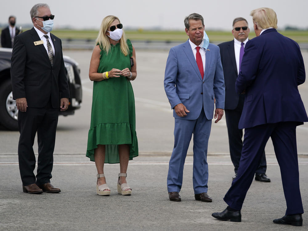 Georgia Gov. Brian Kemp (third from left) greets President Trump at Hartsfield-Jackson Atlanta International Airport on Wednesday.