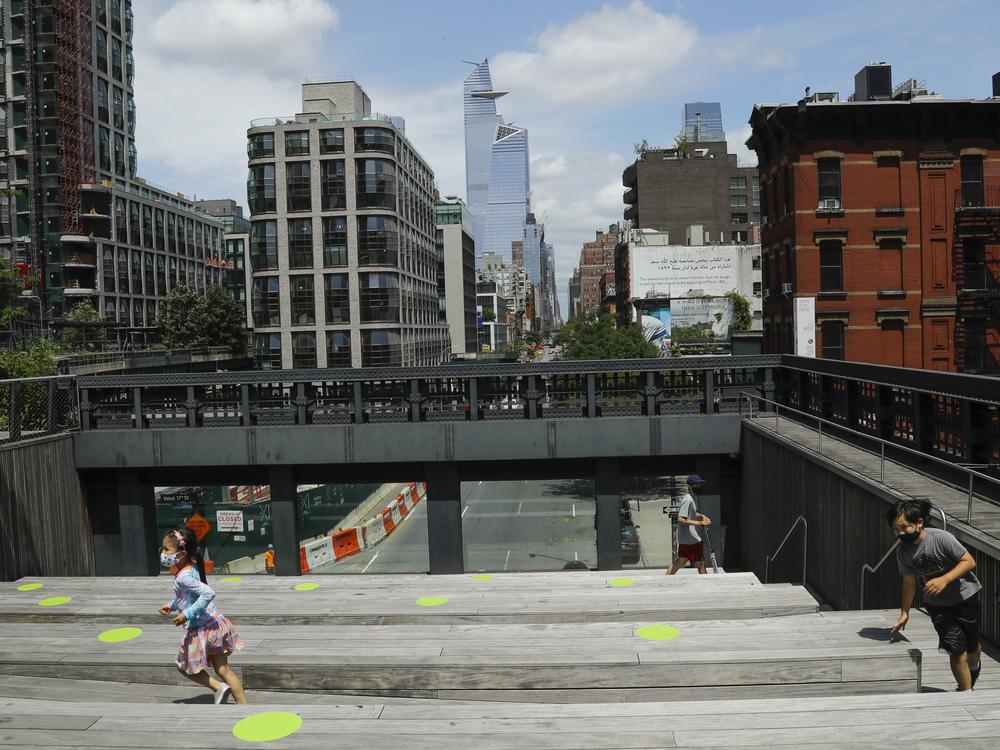 New York City Mayor Bill de Blasio announced that the city will offer free child care to 100,000 students when schools reopen for part-time in-person instruction in September. Here, children play at Manhattan's High Line park on Thursday.