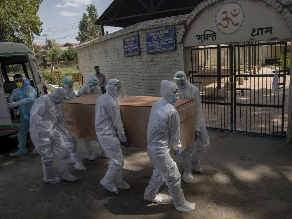 Indian paramilitary soldiers carry the body of a paramilitary officer who died of COVID-19 to a crematorium in Srinagar, Indian-controlled Kashmir, on Tuesday. India is the third-ranked nation in the number of reported infections.