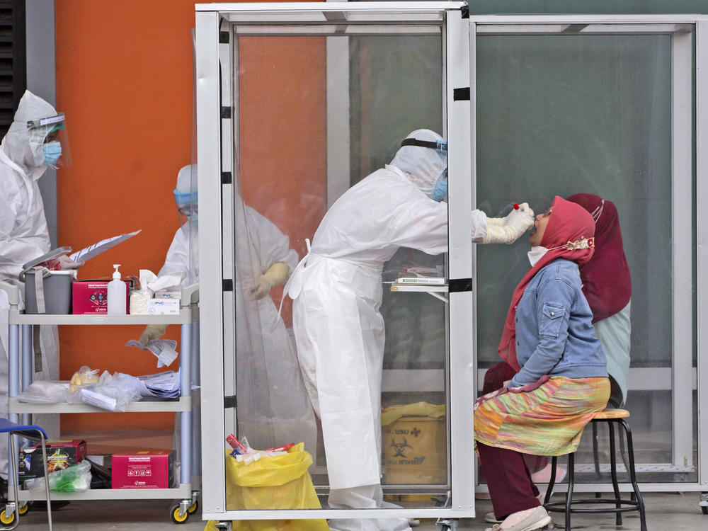 A medical worker collects nasal swab samples this week during a mass test for the coronavirus at North Sumatra University in Medan, North Sumatra, Indonesia. The mass test was held after the rector of the university along with one of his deputies and a member of the board of trustees were tested positive for COVID-19.