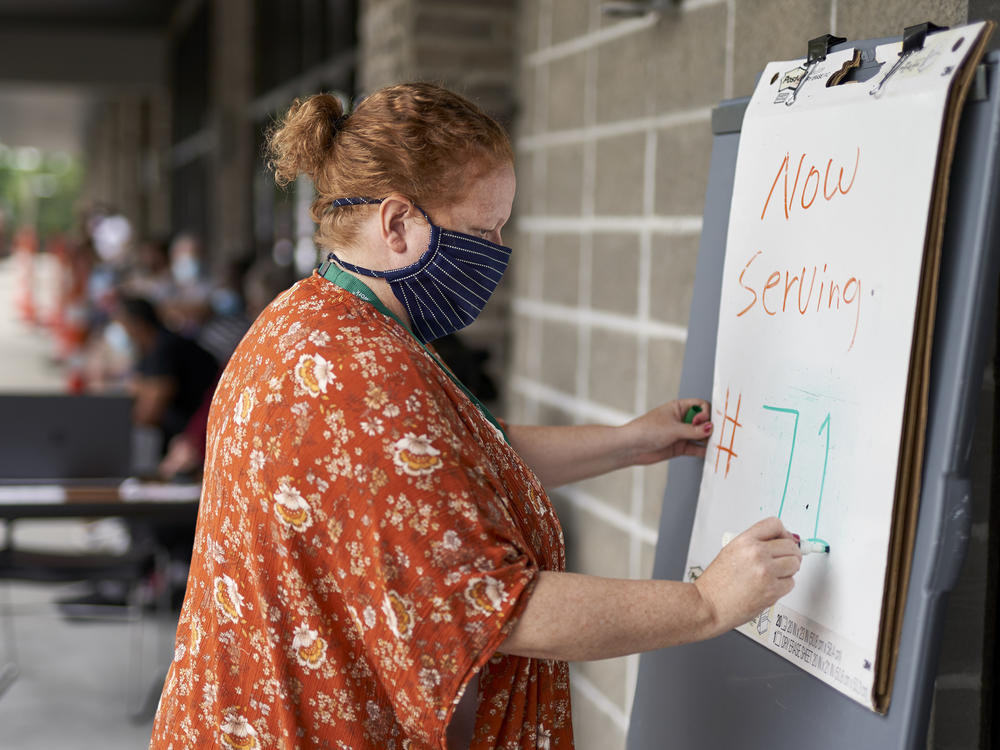 Vickie Gregorio with Heartland Workforce Solutions in Omaha, Neb., updates a whiteboard outside the workforce office as unemployed job seekers wait in line for help. A recent change in federal rules gives some people who have lost their health plan along with their job more than the usual 60 days to sign up for COBRA health coverage.