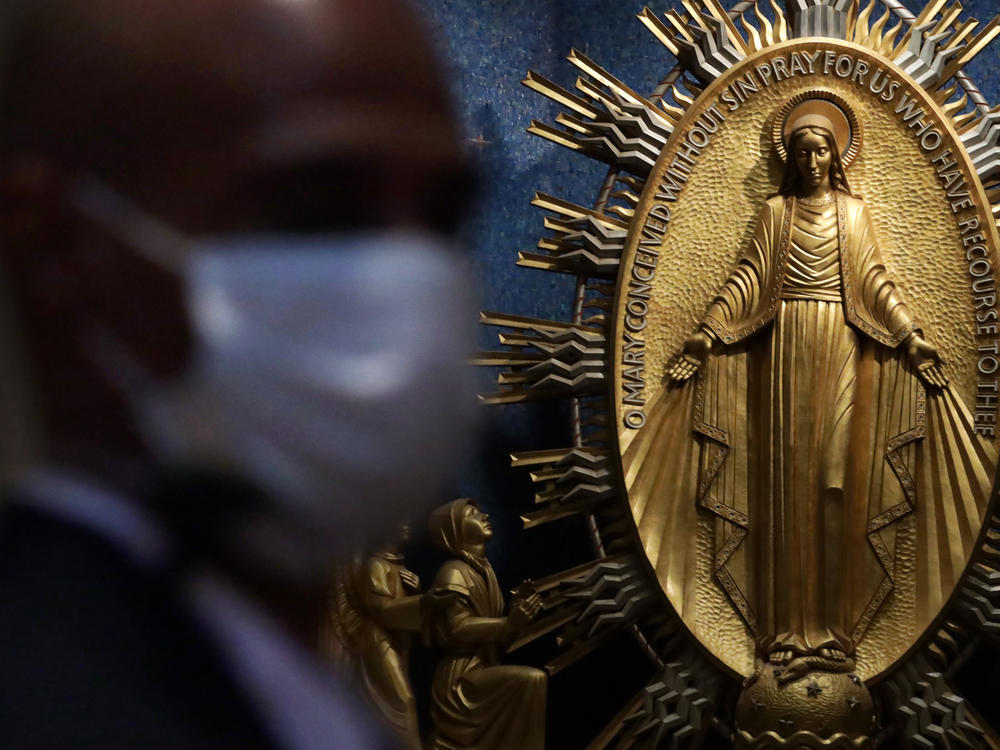 A member of the security personnel wears a mask during a Mass at the Basilica of the National Shrine of the Immaculate Conception in Washington, D.C.