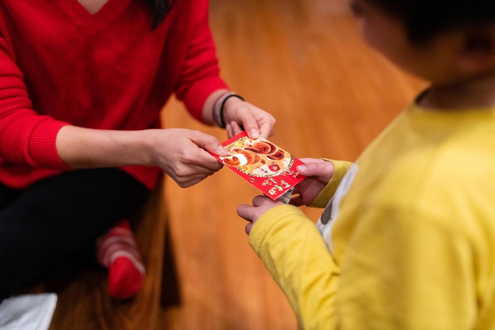 Thao Nguyen gives her nephew, Hayle, a red envelope in celebration of the Lunar New year on Jan. 26, 2020.