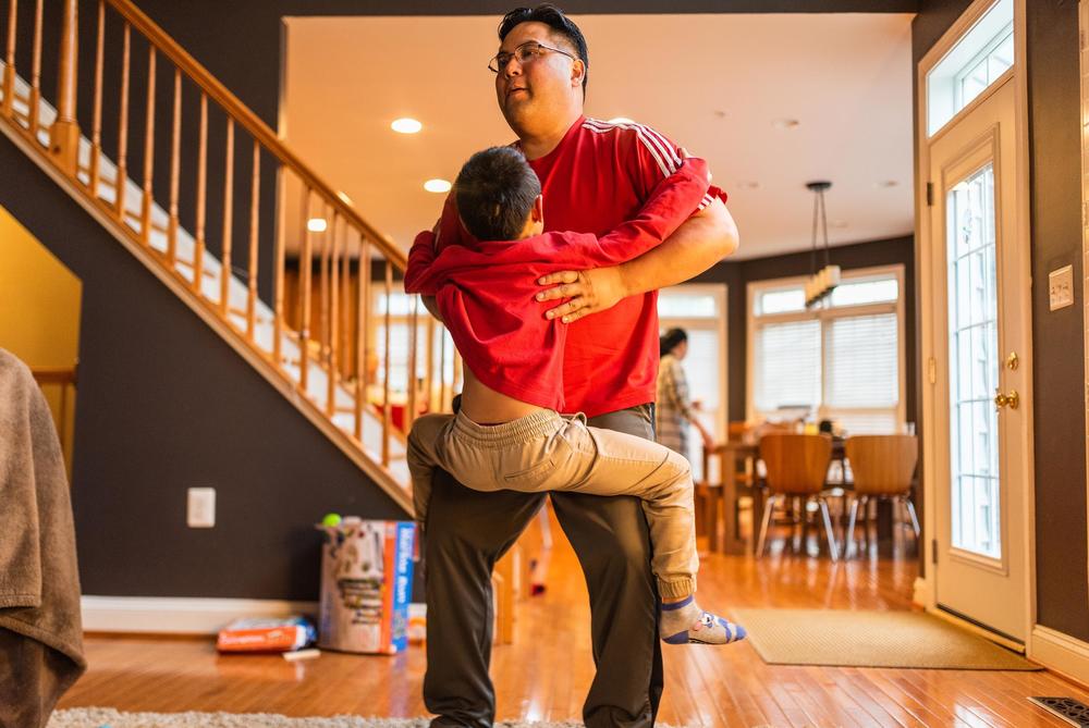 Hansel Pham lifts Henry at home on April 5, 2019.
