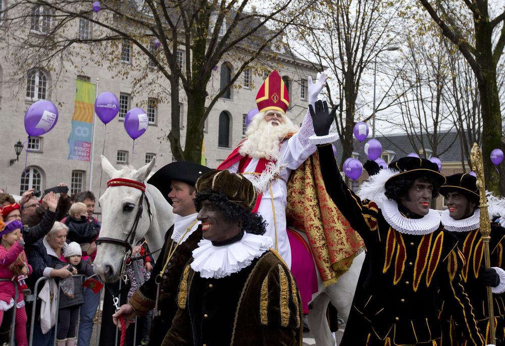 People line the road to greet Sinterklaas and his Black Pete sidekicks in Amsterdam in 2013.
