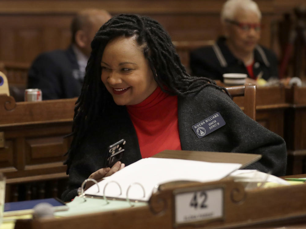 Georgia state Sen. Nikema Williams confers with a colleague on the floor of the Georgia Senate in February.