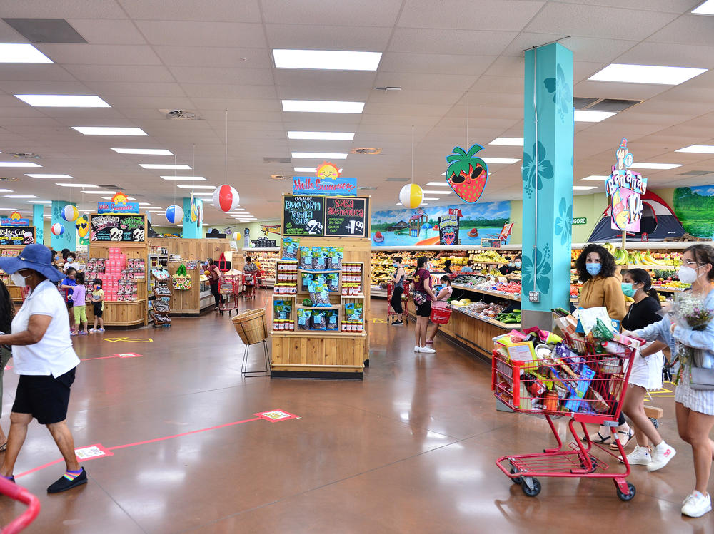 Trader Joe's says it is in the process of discontinuing some of its product branding. Here, shoppers buy groceries at a store last week in Pembroke Pines, Fla.