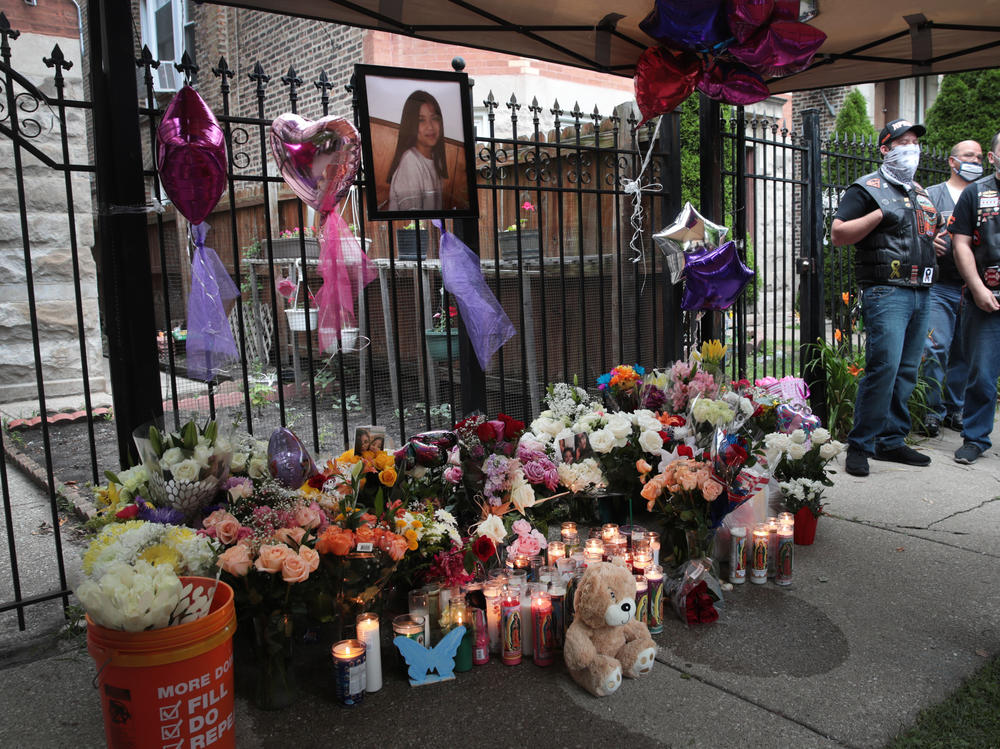 Candles burn in front of a memorial for Lena Nunez, 10, on June 29 in Chicago. The child was shot and killed by a stray bullet while watching TV with her brother in her grandmother's home, reports say.
