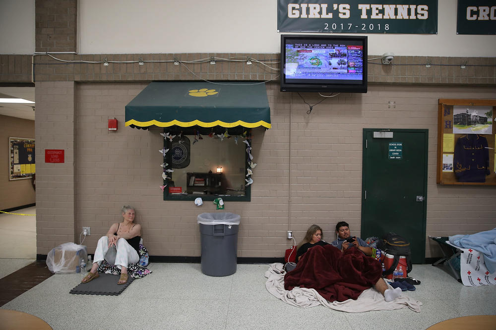 Evacuees wait for the arrival of 2018's Hurricane Florence inside a North Carolina school shelter. Many coastal states have long-standing shelter shortages. That's being exacerbated this year by recommendations from the American Red Cross and the Centers for Disease Control and Prevention to give evacuees up to three times more personal space to allow for social distancing.