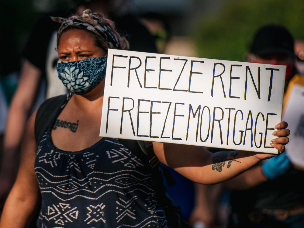 A woman joins with other demonstrators during the 