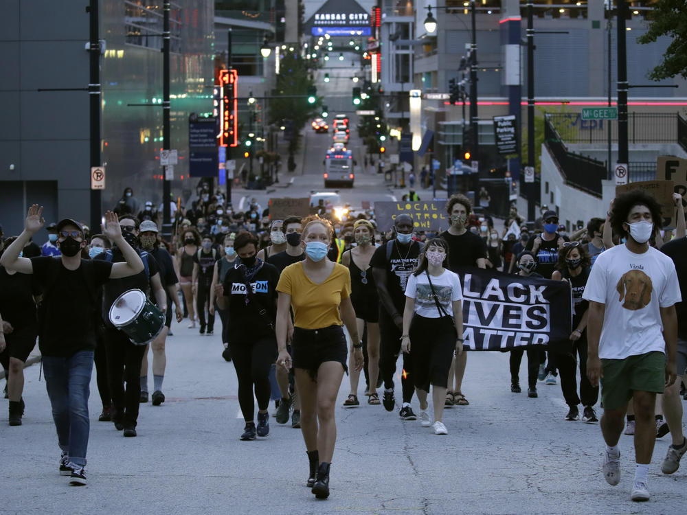 Protesters walk down a street Friday in Kansas City, Mo. They were demanding police reforms and an end to Operation LeGend, which is deploying 200-plus federal law enforcement agents in the city.