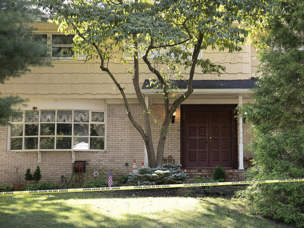 Crime scene tape surrounds the home of U.S. District Judge Esther Salas on Monday in North Brunswick, N.J. A gunman posing as a delivery person shot and killed Salas' 20-year-old son and wounded her husband Sunday evening  before fleeing, according to officials.