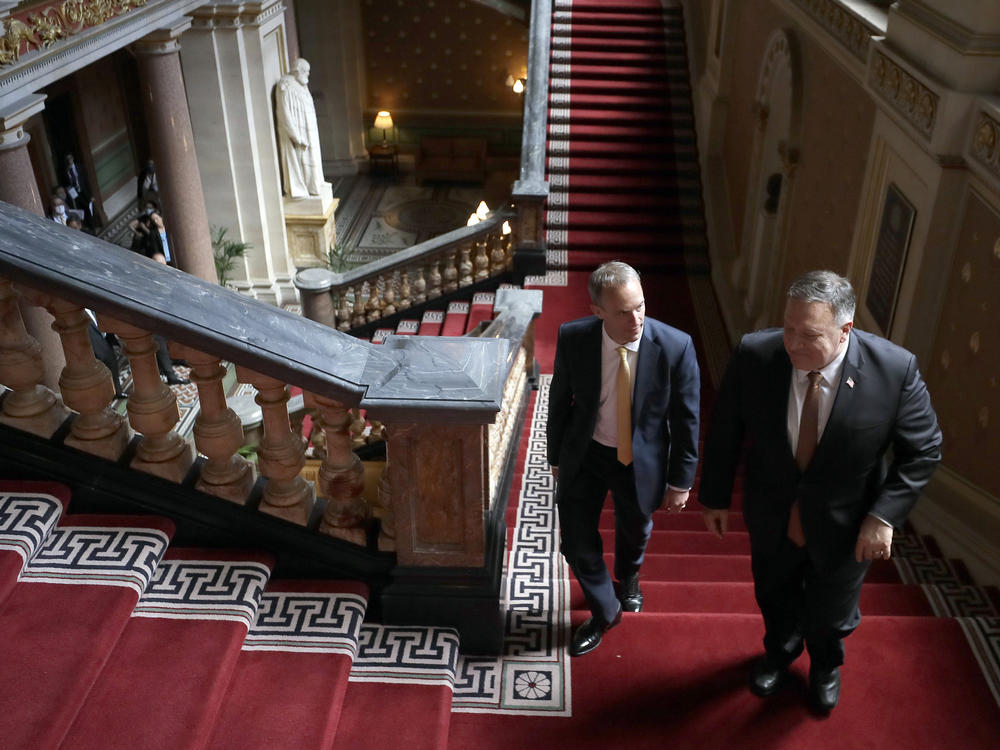 U.K. Foreign Secretary Dominic Raab, left, and U.S. Secretary of State Mike Pompeo walk up the stairs in the Foreign Office in London on Tuesday.