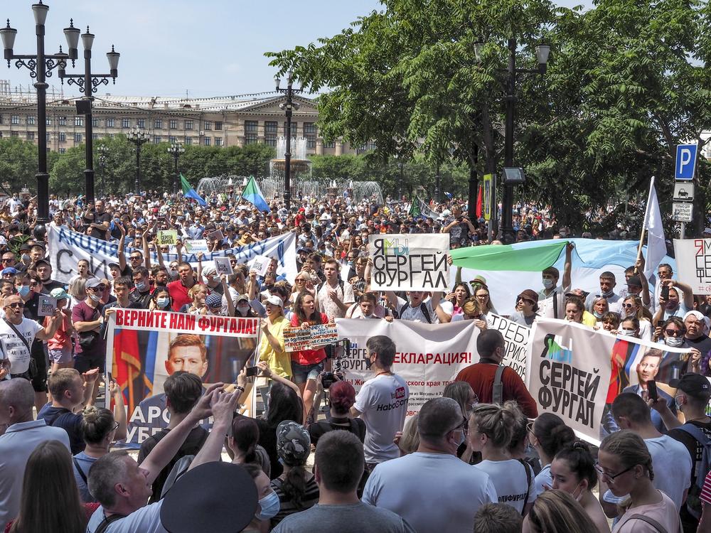 People in the city of Khabarovsk hold posters with messages demanding freedom for Sergei Furgal, the former governor of Russia's Khabarovsk region, on July 18. Protesters have taken to the streets over Furgal's arrest this month on murder charges, which he denies.