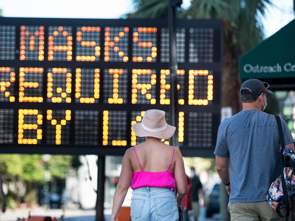 People walk along King Street last week in Charleston, S.C. South Carolina is one of many states in the U.S. struggling with a rising number of coronavirus cases.