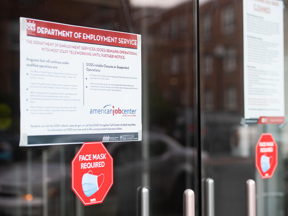 Signs are displayed outside the Washington, D.C., Department of Employment Services. New claims for unemployment benefits around the country rose for the first time in four months.