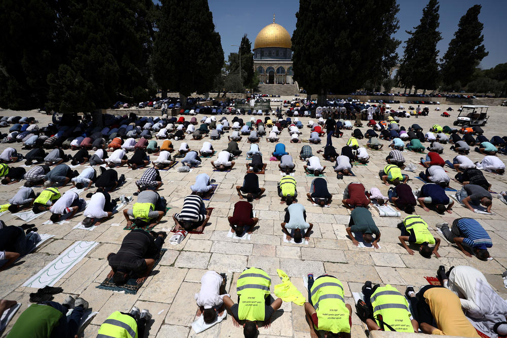 Muslim men practice social distancing during Friday prayers next to the Al-Aqsa Mosque in Jerusalem's Old City in July.