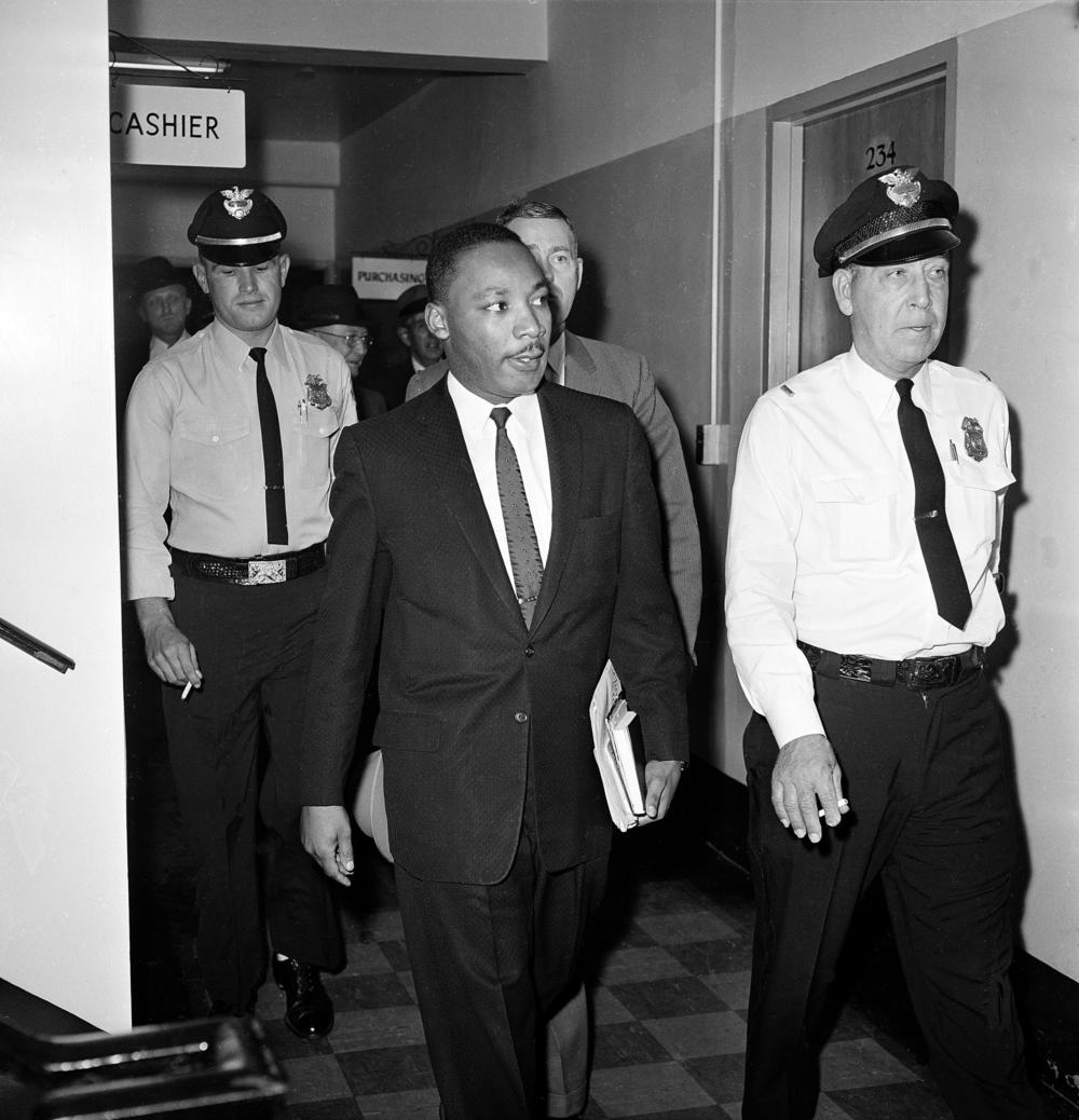  In this Oct. 25, 1960 file photo, Dr. Martin Luther King Jr. leaves court after being given a four-month sentence in Decatur, Ga., for taking part in a lunch counter sit-in at Rich's department store. 