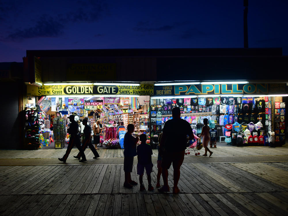 People walk the boardwalk in early July in Wildwood, N.J., after some coronavirus restrictions were lifted. There's concern that case counts could push back up in Mid-Atlantic and Northeastern states.