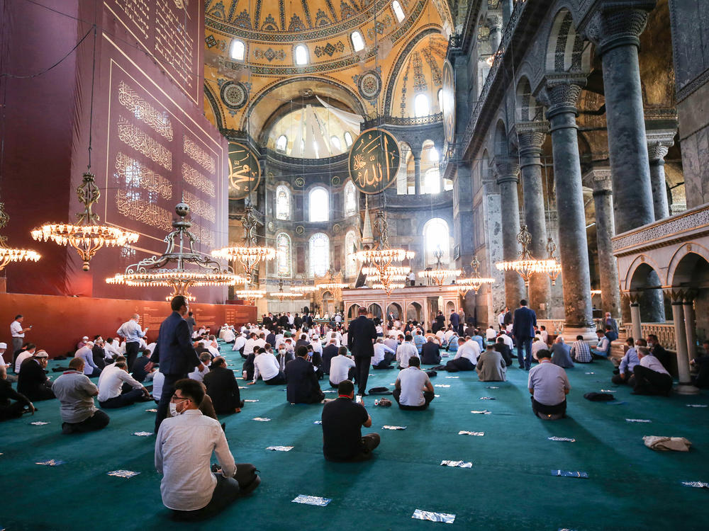 People gather to perform Friday prayers at Istanbul's Hagia Sophia for the first time in 86 years.