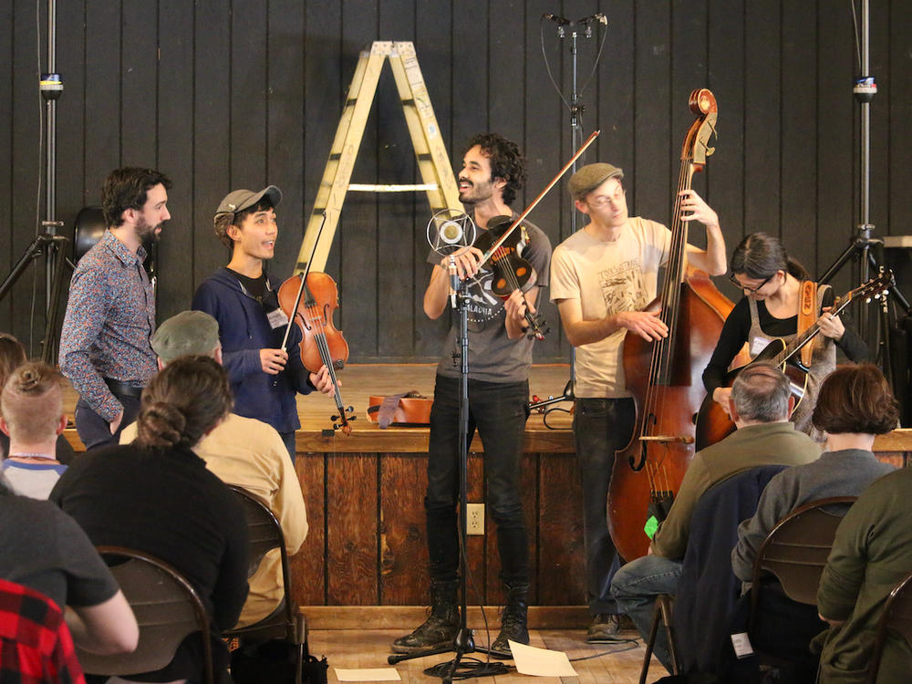 Jake Blount leads a musical performance in his workshop during the Youth Traditional Song Weekend.