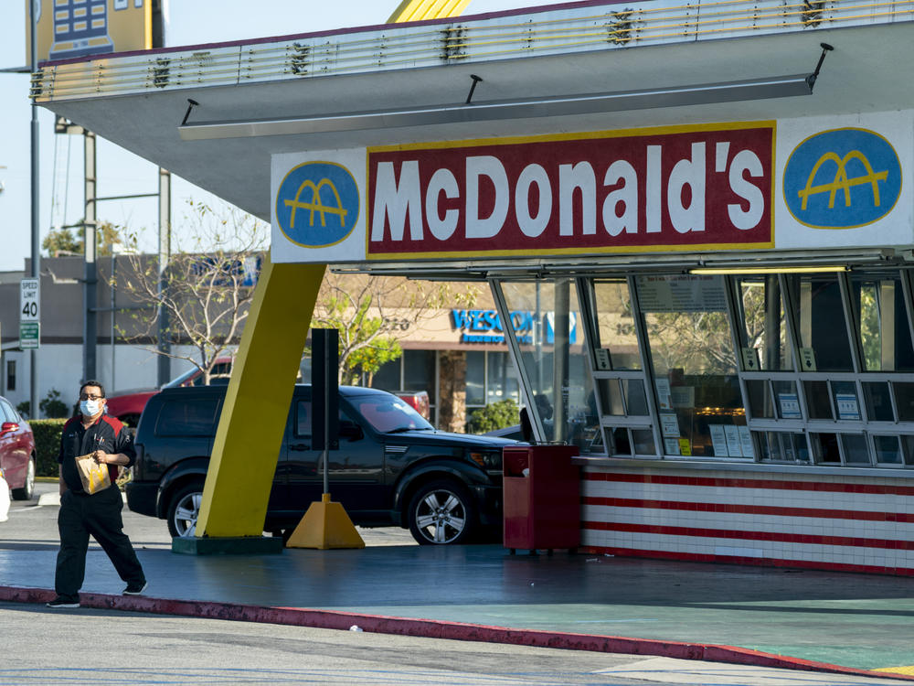 McDonald's will require all customers at its U.S. restaurants to wear a face mask, starting Aug. 1, the company says. Here, a customer wears a mask at the oldest operating McDonald's Corp. restaurant, in Downey, Calif., in April.