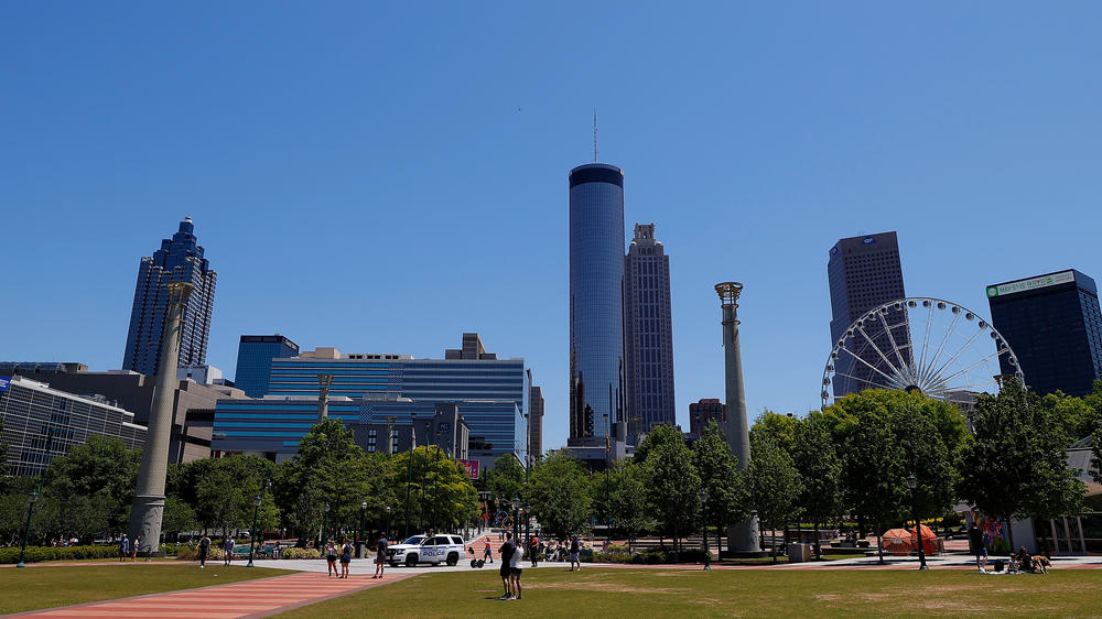 People visit Centennial Olympic Park in Atlanta on May 2. Many families in Atlanta and across the U.S. could face power disconnections as shut-off moratoriums imposed at the start of the pandemic expire. This comes as supplemental unemployment benefits are also set to lapse.