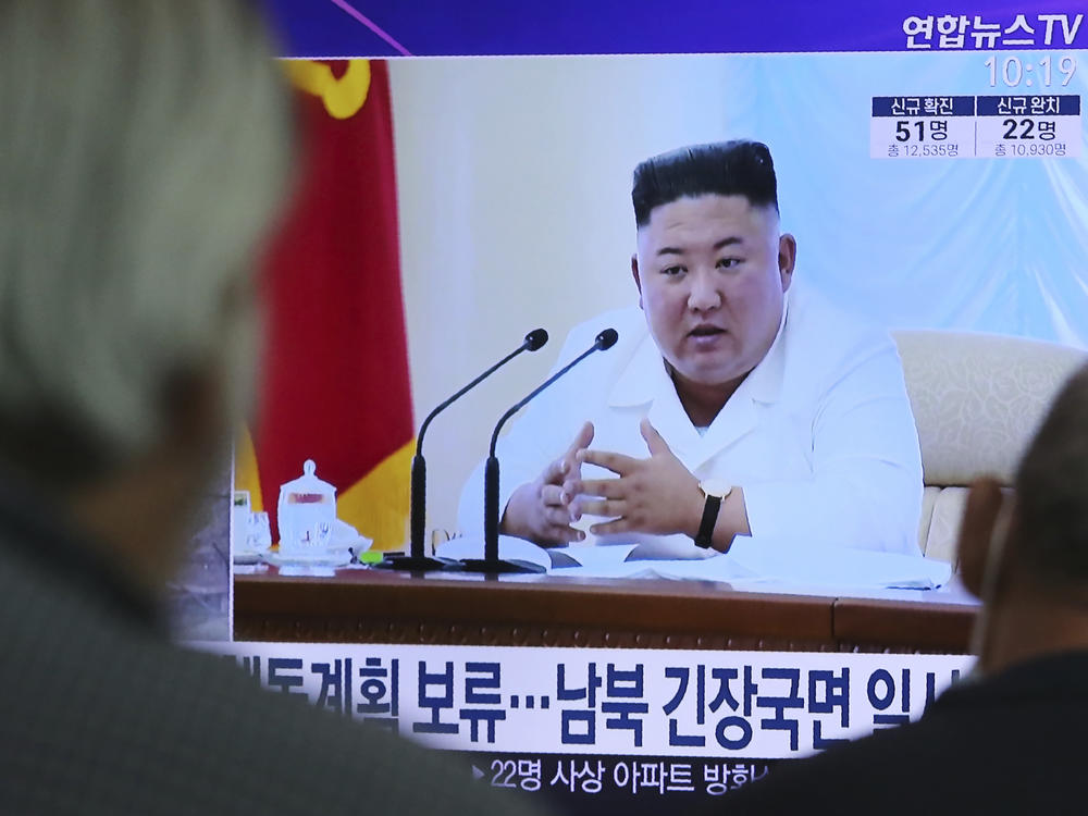 North Korean leader Kim Jong Un appears in a TV news program watched by people in Seoul, South Korea, on June 24.